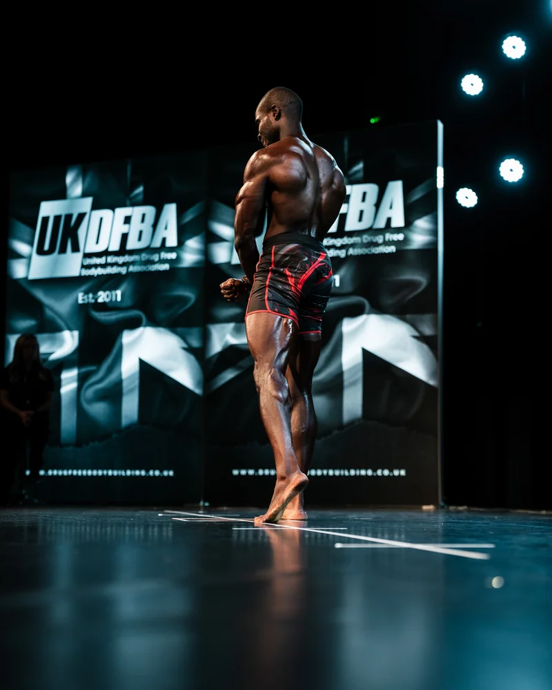 Femi posing on stage at UKDFBA, back shot
